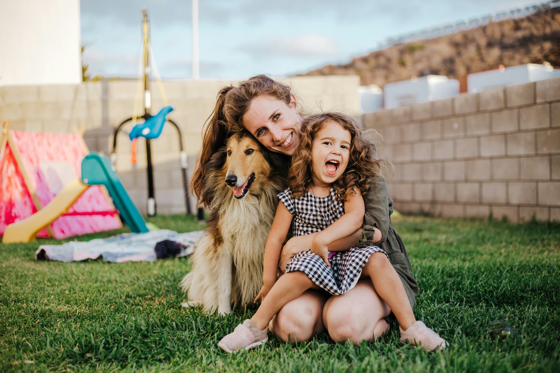 Family enjoying a clean, scooped backyard with their dog